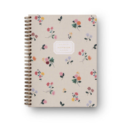 The Ditsy Dahlia Spiral Notebook by Rifle Paper Co. features a beige cover adorned with a colorful floral pattern and elegant gold foil accents, complemented by a white label in the center.