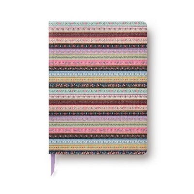 The Gemma Softcover Journal by Rifle Paper Co. is lightweight, with a colorful striped and floral cover, and includes a purple ribbon bookmark peeking from the bottom.