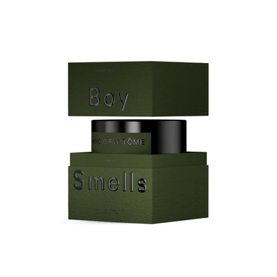 A dark green, square box embossed with Boy Smells splits to reveal the Hinoki Fantome Hero Candle inside—a black jar labeled FANTÔME. This woodsy scented candle is made by Boy Smells.