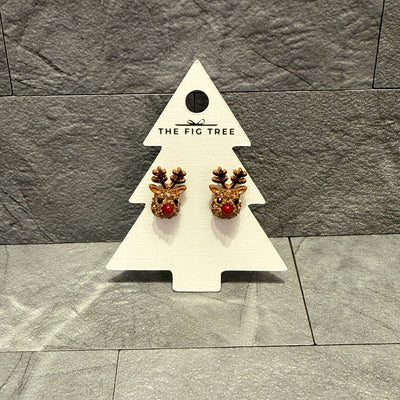 BETTYOH INC Reindeer Post Earrings, displayed on a white tree-shaped THE FIG TREE card against a gray tiled background, feature red noses, antlers, and sparkling rhinestones. These lead- and nickel-free earrings offer comfort and holiday cheer.