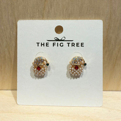 A pair of Christmas Santa Pearl Paved Titanium Post Earrings by Designature New York, featuring hypoallergenic posts, is displayed on a white THE FIG TREE card against a light wood background.