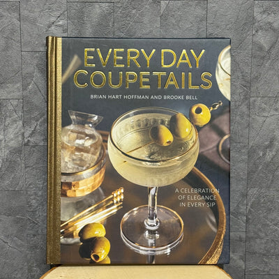 Everyday Couptails by Ingram Publishing is a cocktail recipe book for home bartenders, featuring coupe glass cocktails with olives on the cover set against a textured gray background.