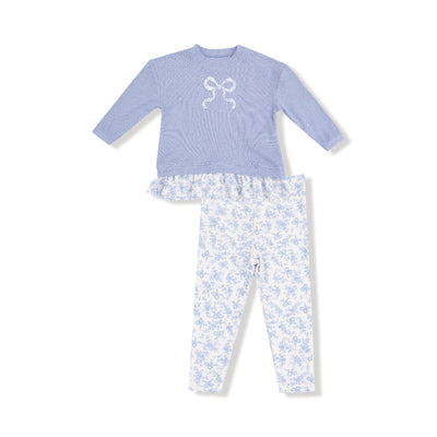 The Romi Floral Waffle Pull Over with Bow and Rib Legging by Angel Dear features a lavender long-sleeve top with bow and ruffled hem, paired with white floral leggings, displayed on a white background.
