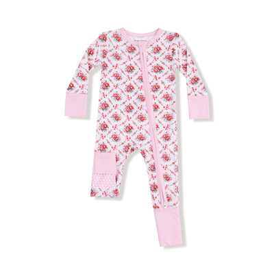 The Rose Bow Lattice Two-Way Zipper Romper by Angel Dear features pink and white bamboo fabric, floral patterns, long sleeves, fold-over cuffs, a diagonal zipper, and a polka dot patch—perfect for sensitive skin.