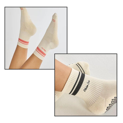 Two images of LUCKY HONEY’s The Pilates Era Grip Sock: one cream pair with red stripes and textured grip soles, feet in the air; the other cream pair with black stripes and “Pilates Club” text, worn on resting feet.