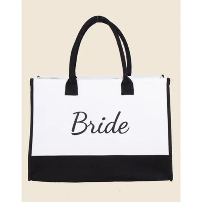 The Anarchy Street Bride Canvas Tote Bag is white with black handles and trim, featuring Bride in elegant script on the front. Measuring 17 x 11, its perfect for carrying your wedding essentials.
