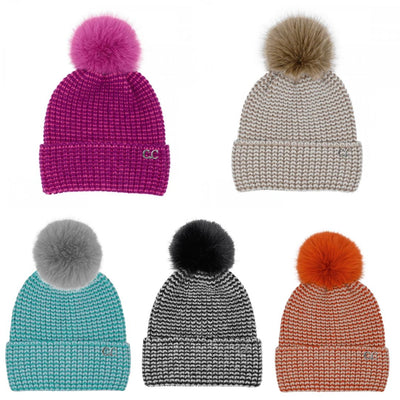 Five Judson & Company two tone angora cuff beanies with large pom-poms are arranged in two rows. Colors (left to right): magenta, beige, teal, black and white, and orange. Each features a CC logo on the cuff.