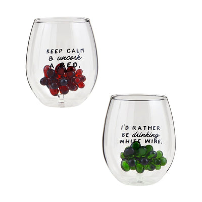 The Grape Icon Wine Glasses by Mud Pie feature two stemless designs: one with a figural red grape cluster reading KEEP CALM & uncork A RED, and the other with green grapes saying ID RATHER BE drinking WHITE WINE. Ideal for a playful toast!.