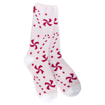 The World's Softest Socks Peppermint Lane Cozy Crew Slipper Socks are fuzzy light pink women’s socks with red and dark pink peppermint candy patterns, small red dots, and white toes and heels—soft, cozy, and perfect for lounging.