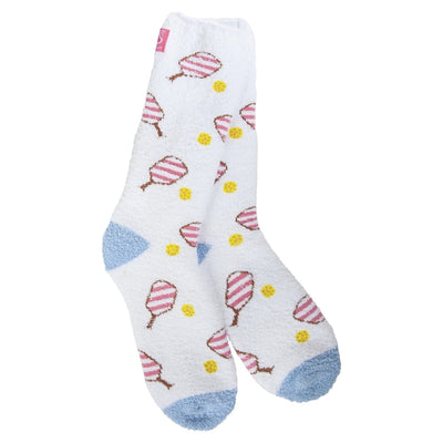 Worlds Softest Socks Pickleball Cozy Crew Slipper Socks feature a pattern of pink and white striped popsicles on white with light blue heel and toe areas, accented by small yellow circles. Made from cozy polyester, theyre designed for womens shoe size 6-10, fitting most sizes.