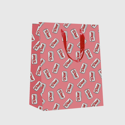 The Brittany Paige Diet Soda Can Gift Bag is pink (8x10.5x4) with repeating white Diet soda can illustrations and bold red satin ribbon handles.
