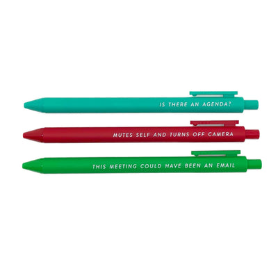 Three jotter pens from Tiny Hoorays Pens for Horrible Meetings are arranged horizontally: teal with IS THERE AN AGENDA?, red with MUTES SELF AND TURNS OFF CAMERA, and green with THIS MEETING COULD HAVE BEEN AN EMAIL. Perfect for tiresome, agenda-less meetings.