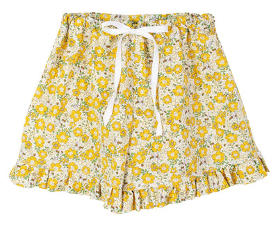 Discover Violet & Brooks Charlotte Ruffle Lounge Shorts: 100% cotton yellow floral shorts with an elastic waistband, white ribbon tie, green leaf accents, and ruffled hems for a touch of elegance.