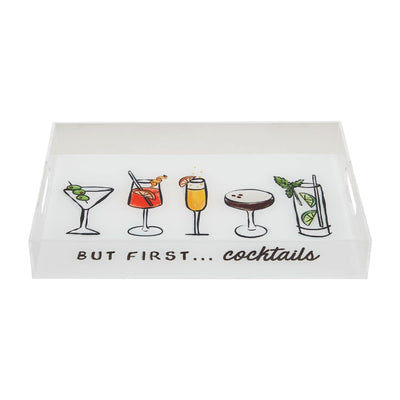 The Mud Pie Acrylic Bar Tray features illustrations of five unique cocktails in distinct glasses with garnishes. BUT FIRST... cocktails is elegantly written beneath the vibrant images in bold black cursive, and side handles ensure easy carrying.