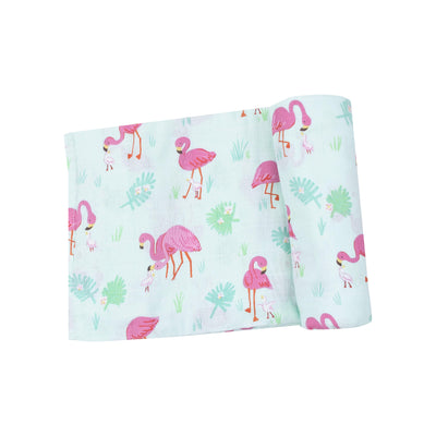 The Angel Dear Flamingos Muslin Swaddle Blanket is crafted from organic cotton muslin with a charming pink flamingo and light green leaf pattern on a pale blue background. Its perfect for swaddling and conveniently machine washable for easy care.