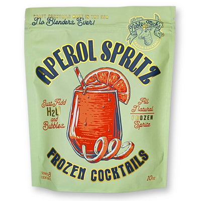 A 10 oz green pouch labeled Aperol Spritz Frozen Cocktail by NOBLE MICKS displays a vibrant glass filled with an orange drink, ice, and a straw topped with an orange slice. The package promises Just Add H2O and Bubbles using all-natural ingredients, ideal for fans of Noble Micks concoctions.