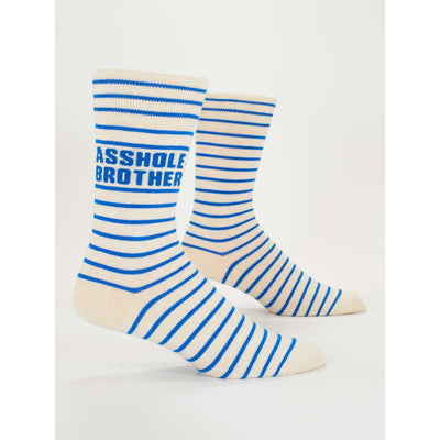 The Asshole Brother Mens Socks by Blue Q feature cream-colored fabric with blue stripes and ASSHOLE BROTHER in bold blue letters near the top. Made from soft combed cotton, these mens socks are shown side by side on a white background.