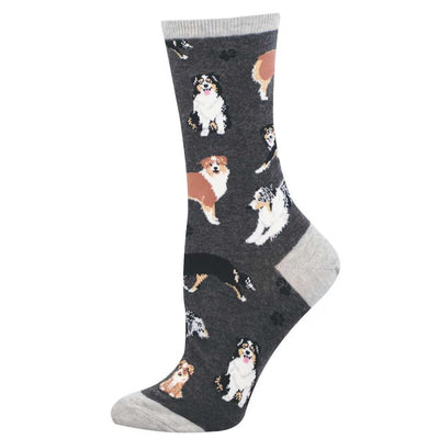 The Aussies Womens Socks by Socksmith are gray, size 9-11, with light gray heel and toe, featuring playful Australian Shepherd dog illustrations. Made from soft cotton for all-day comfort.