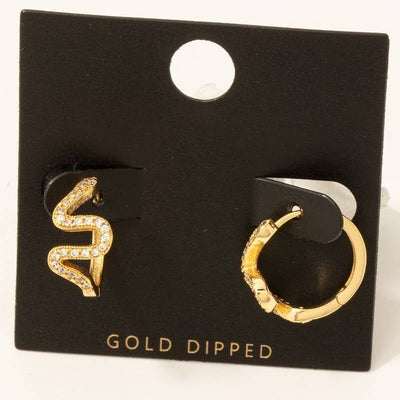 The Fame Accessories Gold Dipped Cz Zigzag Pave Hinge Hoop Earrings set includes two mismatched gold hoops on a black "GOLD DIPPED" card: one features a cubic zirconia zigzag snake design, the other is a simple gold hoop.