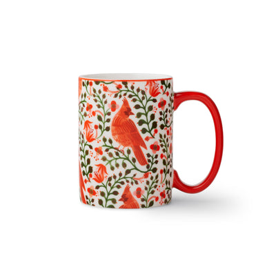 The Cardinals Porcelain Mug by Rifle Paper Co. features vibrant red cardinals, green leaves, and red flowers on white porcelain with a red handle—an ideal seasonal addition to your mug collection.