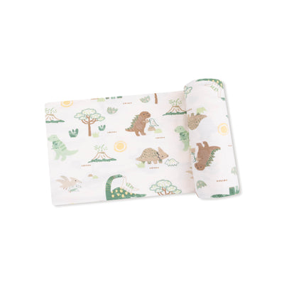 The Angel Dear Baby Loves Dinos Bamboo Stretch Knit Swaddle Blanket features a playful dinosaur print in green, brown, and yellow on a white background.