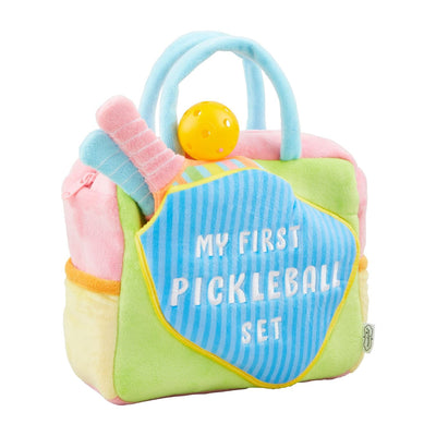 A colorful plush minky pickleball set from Mud Pie, named My First Pickle Ball Set, featuring attached paddles and a ball in pastel pink, blue, green, and yellow, all neatly packed in a storage bag.