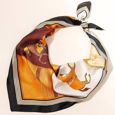 The Sensibling Corp. Equestrian Horse Printed Square Silky Satin Scarf features orange, brown, black, and white tones with an elegant horse motif, shown tied loosely on a light surface.