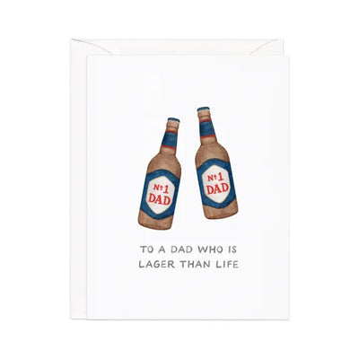 The Lager Than Life Fathers Day Greeting Card by Amy Zhang features an illustration of two beer bottles labeled No. 1 Dad, printed in the USA. It comes with a kraft envelope and includes the message, To a dad who is lager than life.