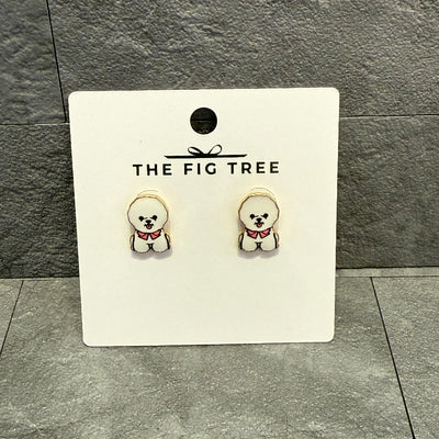A pair of adorable Bichon-shaped stud earrings, each crafted with a gold brass base, displayed on a Golden Stella card labeled Bichon Post Earrings against a gray tiled background.