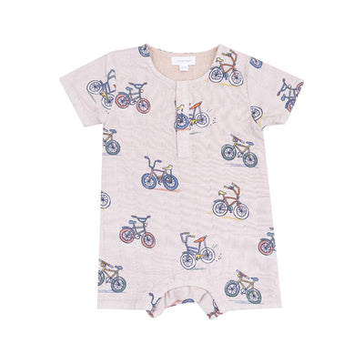 The Bikes Henley Shortall by Angel Dear is a charming, light-colored baby romper made from soft organic cotton. It features a playful bicycle pattern, short sleeves, and convenient bottom buttons and snaps for easy changing.