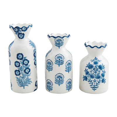 A trio of Mud Pie’s Block Print Bud Vases, each hand-painted with unique blue floral patterns featuring diverse flower and leaf motifs. Display them in a row against a plain background for an elegant way to showcase your favorite stems.