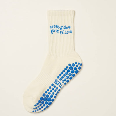 White sock with blue text and sole pattern on a light beige background