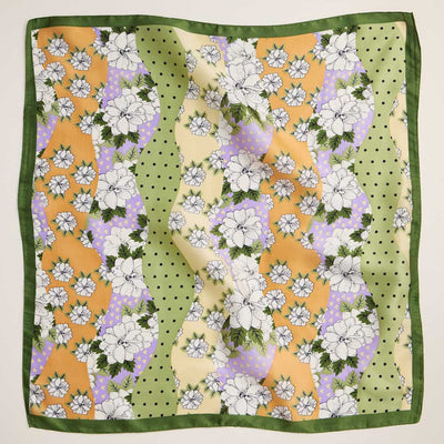 The Retro Floral Patchwork Printed Square Silky Satin Scarf by Sensibling Corp. features green edges, wavy yellow, lavender, and light green bands, black polka dots, and bold white floral patterns for a retro look.