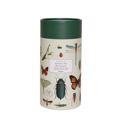 A cylindrical box from 123 Farm with a dark green lid features vintage insect illustrations. The label reads "Insects Puzzle – 500 Pc Tube with Vintage Illustrations.
