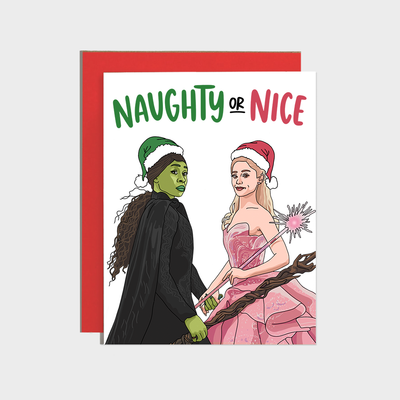 The Brittany Paige Naughty or Nice Witch Holiday Card features two women dressed as witches with festive hats, printed on high quality paper with a white background and paired with a matching red envelope.