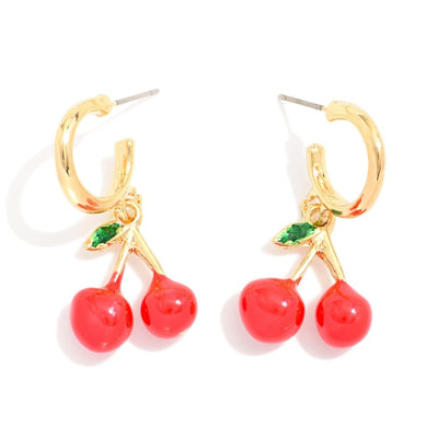 The Cherry Huggie Hoop Earrings by Judson & Company feature gold hoops with dangling red cherry charms—each with two cherries and a small green leaf. Measuring about 1 long, theyre shown on a white background.