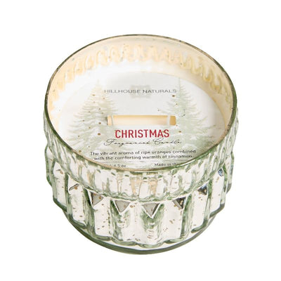 The Hillhouse Naturals/Field+Fleur 9.5oz. Christmas 2 Wick Mercury Candle features a white wax interior, festive pine tree design, and holiday scent—ideal for long-lasting ambiance at cozy gatherings.