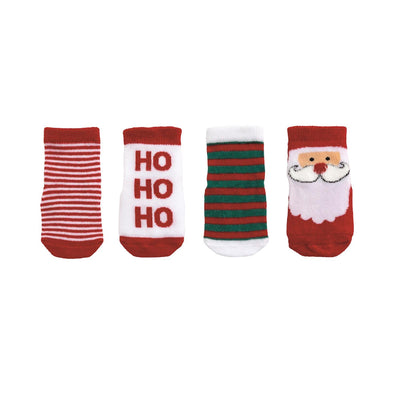 The Mud Pie Christmas Baby Sock Set includes four cotton socks for 0-12 months: red and white stripes, HO HO HO text, green and red stripes, and Santa face, all with festive red accents.
