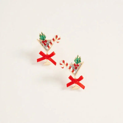 Golden Stella’s Christmas Cocktail Glass & Bow Earrings feature festive martini glass shapes with holly leaves, red berries, a candy cane, and a red bow. Made in China from zinc, each measures about 1 inch and is set against a white background.