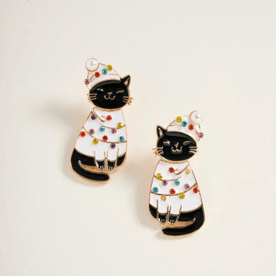 Golden Stella's Christmas Lights Cats Earrings feature black cat designs with white Christmas hats and sweaters decorated with colorful holiday dots. Each 1.5-inch earring has an enamel metal base and a light background.