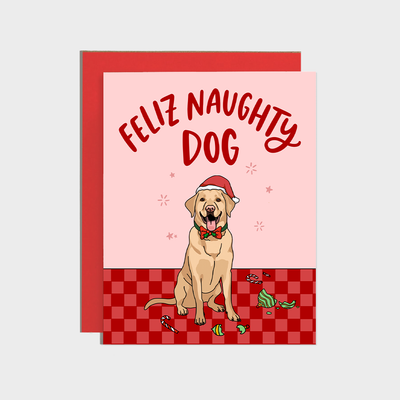 The Brittany Paige "Feliz Naughty Dog Labrador Card" features a labrador in a Santa hat and bow tie on a red checkered floor with torn ornaments, "Feliz Naughty Dog" text above, printed on high quality paper. Includes matching envelope.