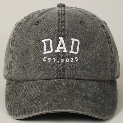 The Fashion City Dad Est. 2025 gray baseball cap is crafted from 100% cotton, featuring white embroidered text and an adjustable strap for comfort and sentimentality.