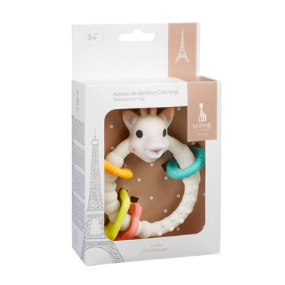 The Teething Colo Rings by Sophie la Girafe from Calisson Toys is a natural rubber teething toy adorned with colorful rings and a cute giraffe design. The box, labeled for ages 3 months and up, features an Eiffel Tower illustration and offers perfect relief for babys sore gums.