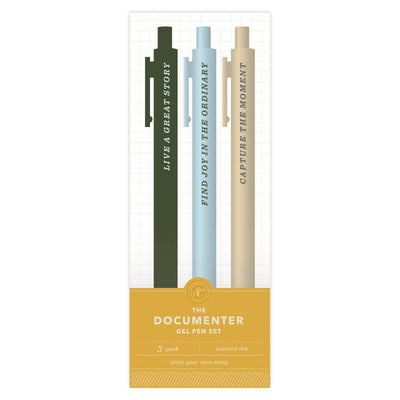 The Studio Calico Documenter Pen Set includes three pens—dark green, light blue, and beige—each featuring phrases: “LIVE A GREAT STORY,” “FIND JOY IN THE ORDINARY,” and “CAPTURE THE MOMENT.”.