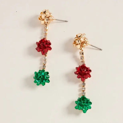 Golden Stella's Christmas Bows & Bling Earrings feature festive 2" designs with gold, red, and green gift bows stacked vertically and linked by sparkling rhinestones, all crafted from zinc.
