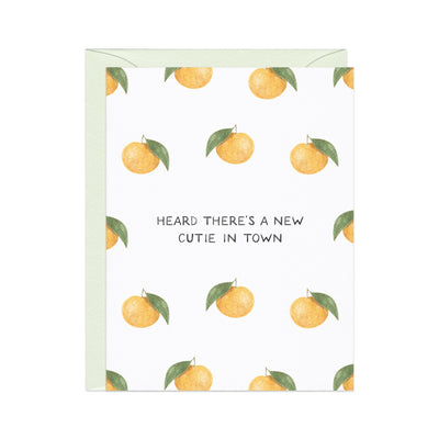 card with clementine fruit that says theres a new cutie in town