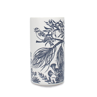 The Song Bird Woodland Navy Ceramic Vase by Half Moon Bay By Design features navy blue botanical and bird illustrations on white ceramic, adding woodland charm with branches, leaves, flowers, and a perched bird to your space.