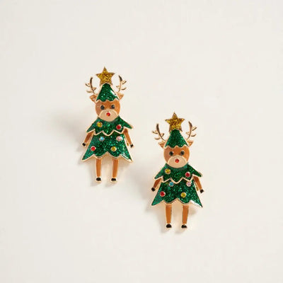 The Golden Stella Vixen Earrings are festive 1.5-inch enamel pieces featuring cartoon reindeer in Christmas tree costumes with gold antlers, decorated with ornaments and stars, crafted from zinc and shown on a white background.