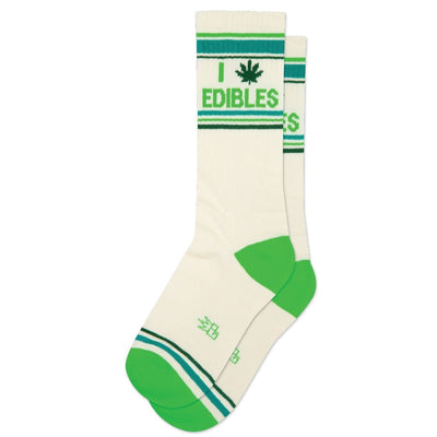 Gumball Poodle’s I (Pot Leaf) Edibles Gym Crew Socks are white with green toes, heels, and stripes, and feature “I” with a cannabis leaf and “EDIBLES” in green for a fun, playful vibe.