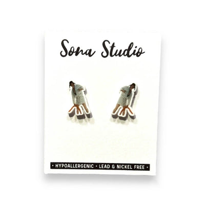 A pair of Septic Eddie Christmas Vacation earrings by Sona Studio featuring hypoallergenic, lead- and nickel-free handmade studs with stainless steel posts for sensitive ears, displayed on a branded white card.
